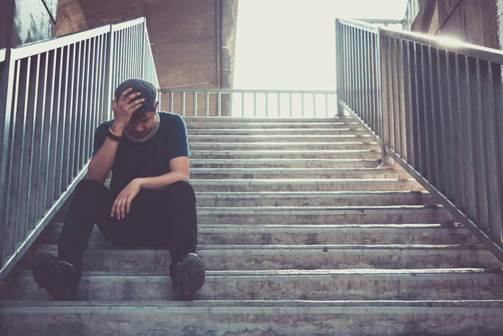 Persona deprimida sentado en escaleras